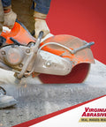 Worker using saw with Sparkie Premium Diamond Blade For Concrete Cuts, 14 Inch Wet Or Dry Saw Blade With 12mm Segments.