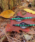 2 Inch Hunt Ready Vane For 3D Setups Black 50 Pack AR1000 Material Forgiving Flexible Durable Arrow Vane outdoors on autumn leaves.