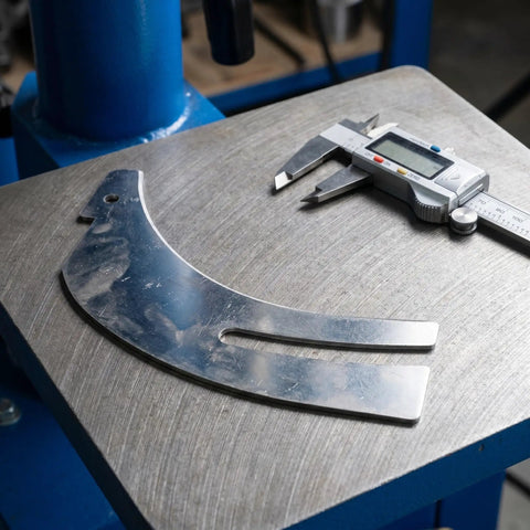 Rock Solid Table Saw Riving Knife Metal Splitter Guard on workshop table with calipers for precise measurement.
