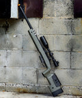 6mmProShop PDI Custom Upgraded USMC M40A5 Cycling Action Airsoft Rifle OD Green leaning against wall