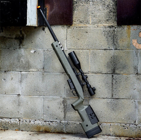 6mmProShop PDI Custom Upgraded USMC M40A5 Cycling Action Airsoft Rifle OD Green leaning against wall