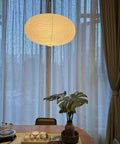 Large White Chinese Paper Ceiling Lamp Shade And Oval Pendant Light Cover With Vintage Round Chandelier Lantern Design, cozy dining area.