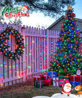 2 Pack Solar String Lights 100 LEDs Over 32.8 Feet Multicolor Waterproof Outdoor Decor For Garden Wedding Party Home Christmas Tree Curtains And More 8 Modes Solar Powered No Outlet Needed decorating a Christmas tree and fence outdoors.