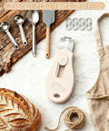 Beige Magnetic Bread Lame For Home Bakers And Dough Nerds With Dual Sided Locking Blade, includes five razor blades, on table.