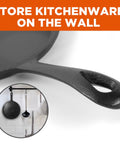 Close-up of cast iron griddle handle for Three Piece Cast Iron Griddle Set Pre Seasoned For Easy Cooking Includes 8 Inch 10 Inch And 12 Inch Griddles Works On All Cooktops Including Induction Ideal For Stovetop Oven Campfire And Outdoor Barbecues Cook Up A Storm, shown hanging in kitchen.