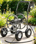 Garden Hose Reel Cart With 250 Ft Capacity, 10 Inch Pneumatic Tires, Powder Coated Steel Frame in a garden setting.