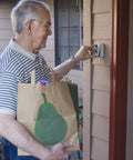 Elderly man using AccessPoint Slimline Push Button Key Safe Lock Box With Weather Cover For Wall Mount Holds Two Keys No Fuss Easy Access Keybox Bundle For Home Or Office Weather Resistant And Secure, attached to wall, carrying grocery bag.