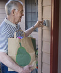 Elderly man using Slimline Push Button Key Safe Lock Box For Wall Mount Holds Up To Two Keys With Easy Code Access
