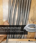 Three Quarters Inch Galvanized Steel Flexible Electrical Conduit 25 Ft Roll installed on wooden wall, hand pulling conduit