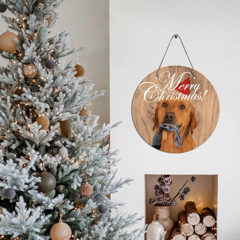 Six Round Sublimation Door Hanger Blanks For DIY Wall Decor with dog image and 'Merry Christmas' text on wall near Christmas tree