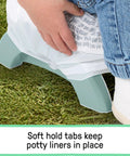 Road Warrior 2 In 1 Portable Baby And Toddler Travel Potty Seat with secure soft hold tabs for liners on grass.