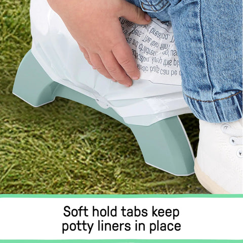 Road Warrior 2 In 1 Portable Baby And Toddler Travel Potty Seat with secure soft hold tabs for liners on grass.