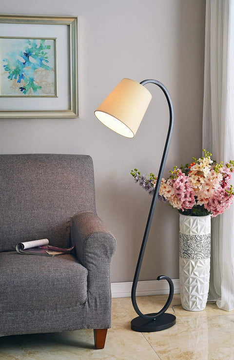 Oil Rubbed Bronze Floor Lamp With Elegant Scroll Design next to a gray sofa, floral vase, and artwork, 55.75 inches tall, 19.5 inches wide