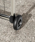 Heavy Duty 6 Inch Gate Wheel Caster for 1 5/8 to 2 1/2 inch round tube gates with black finish, shown on gravel
