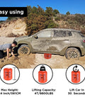 BotaBay 4 Ton Off-Road Air Jack With 8800 Lbs Capacity Inflatable Soft Jack used to lift a muddy SUV on sand.