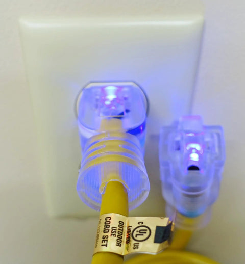 Heavy Duty 30 Ft Extension Cord With Sharp Blue Led Lights On Both Ends connected to wall socket, showing flexible yellow jacket, UL Listed.