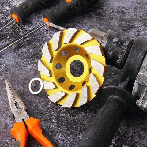 4 Inch Turbo Diamond Grinding Cup Wheel With 12 Segments For Concrete Tile Marble And Rock, Heat Treated Cup Design For Long Life, Ideal For Angle Grinders, 0.86 Inch Arbor, Heavy Duty Grinding On Hard Surfaces on a workbench next to pliers and screwdriver