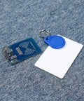 Mifare RC522 NFC Reader Module Kit With S50 White Card And Key Ring displayed on blue surface