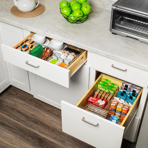 Kitchen cabinet drawers organized with pantry bins, perfect for snacks and small foods, highlighting neat storage solution.