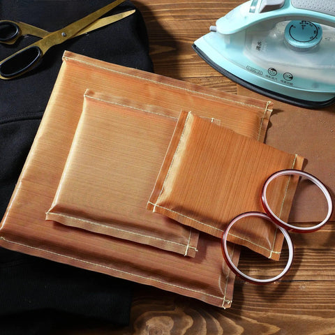 Three Size Heat Press Pillow Bundle with One Transfer Paper and Two Rolls of Heat Resistant Tape for T Shirts Iron On and Screen Printing DIY Coffee Edition on a wooden table with iron and scissors.