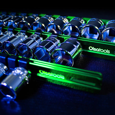 Close-up of Aluminum Socket Organizer Rail Set For 1/2, 3/8, And 1/4 Drives - Green, holding chrome sockets on black surface.