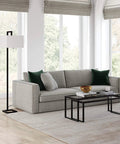 68 Inch Tall Floor Lamp With Linen Fabric Shade In Polished Nickel Finish next to modern gray sofa in living room