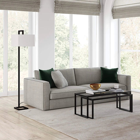68 Inch Tall Floor Lamp With Linen Fabric Shade In Polished Nickel Finish next to modern gray sofa in living room