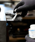Applying Anti Seize High Tech Assembly Paste 450 G Metal Free High Temperature Resistant to machinery component.