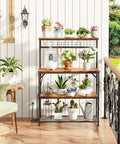 Rustic Brown Kitchen Bakers Rack With Power Outlets And A 31.5 Inch Desktop Four Tier Storage Coffee Bar Station With Eight S Hooks Microwave And Spice Organizer For Pots And Appliances featuring potted plants