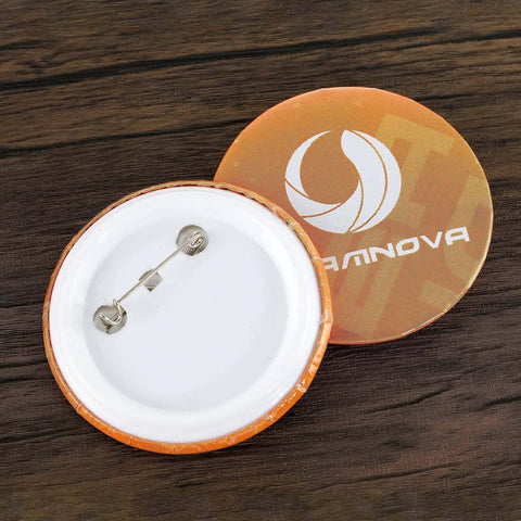 Back view of a round pin badge from the DIY 58mm Button Maker Machine Kit with 1000 Button Blanks and Circle Cutter Included, shown on wood surface.