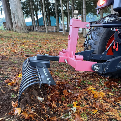 Side view of a 48 Inch Tow Behind Landscape Rake With 17 Steel Tines For ATV UTV And Tractor, 2 Inch Receiver, landscaping debris.