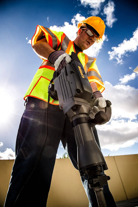 Worker using Ground Rod Driver with TR One Shank for TR 100 and TR 300 Demolition Jack Hammers, sunlight in background