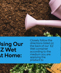 Pink watering can next to soil and green plants. Text about using EZ Wet Soil Penetrant 26 Percent Biodegradable Non Ionic Surfactant.