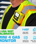 Compact 4 Gas Monitor USB Rechargeable on worker's vest, showing LED display and factory calibration label