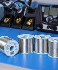 Sn60Pb40 Flux Core Solder Wire 1.0 Millimeter Diameter 100 Gram Spool Two Point Two Percent Flux Delivers Consistent Flow For Reliable Joints On Electronics PCBs And Tough Surfaces displayed on a blue workbench.