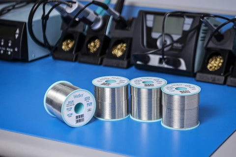 SAC Lead Free Solder Wire 0.5mm Diameter, 100g Roll, Sn96.5Ag3.0Cu0.5 Flux 3.5 Percent spools on a workbench