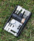 Compact Bicycle Multi Tool With CO2 Inflator And Chain Tool For Road And Mountain Bikes Torx Hex Screwdriver Set shown on grass