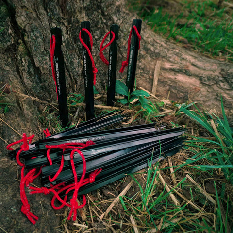 Beefy 16 Pack 7075 Aluminum Tent Stakes 7.25 Inch Long Heavy Duty Ground Pegs Rust Resistant for camping, on grass by tree