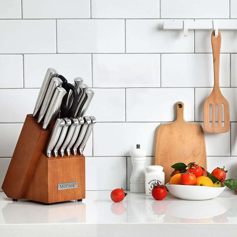 German Stainless Steel Kitchen Knife Set With Built In Sharpener in wood block on kitchen counter with cutting boards and fruits