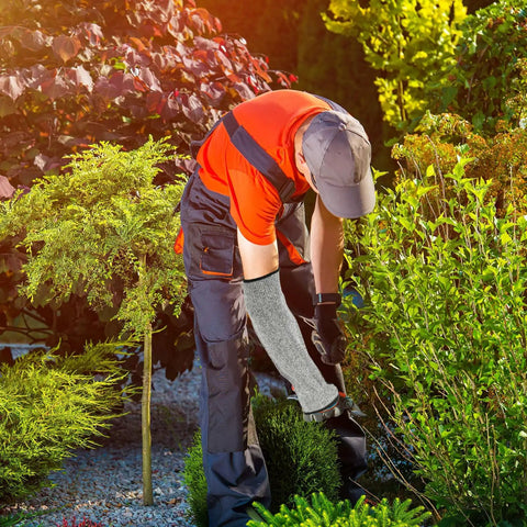 Man gardening with Built Like A Tank Cut Resistant Arm Sleeve Featuring Tough Hppe Knit and Stretch Fit Design for mechanics.
