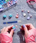 Hands crafting jewelry with beads and tools, illustrating 21-Piece Drill Bit Set With Pin Vise For Jewelry Bead Making And Tiny Wood Carving