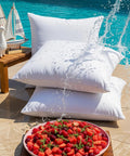 Outdoor Pillow Inserts 18 By 18 Inches Pack Of 2 White No Fuss Water Resistant Throw Pillows by poolside with platter of fruit