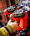Hand gripping Vulcan 180 Lantern Cranks Out 1200 Lumens With 548M Beam, 180-Degree Articulating Head That Locks Forward, Orange
