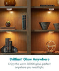 Battery Powered Under Cabinet Lights With Tap Technology illuminating wooden shelves with decor and books, no wiring required