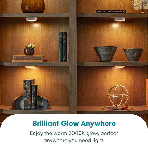 Battery Powered Under Cabinet Lights With Tap Technology illuminating wooden shelves with decor and books, no wiring required