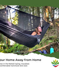Woman relaxing in a Bug Free Sky Bed Camping Hammock Tent with Flat Lay Sleep in a forest, highlighting asymmetrical design.