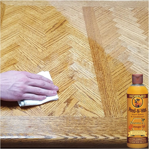 Hand applying Beeswax Wood Polish And Conditioner With Orange Oil For Furniture Feed-N-Wax Restorer to wood table surface.
