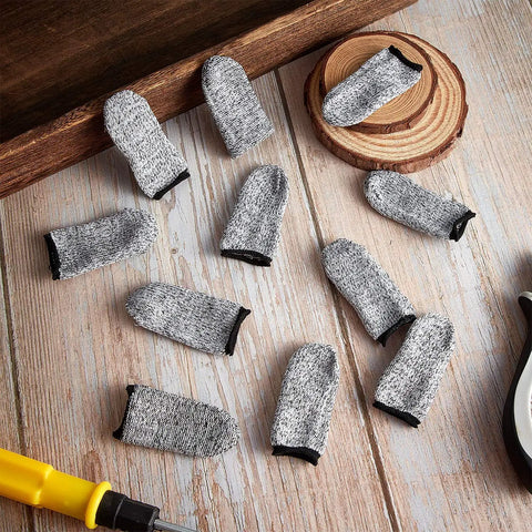 Assorted 20 Piece Cut Resistant Finger Cots And Finger Sleeves Reusable Thumb Protectors laid out on a wooden surface