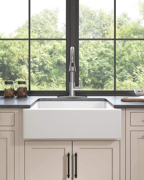 YZZY Single Handle Kitchen Sink Faucet with Pull Down Sprayer Stainless Steel Single Hole Bar Faucet High Arc Chrome Pull Out Kitchen Faucet installed in kitchen sink with natural light.