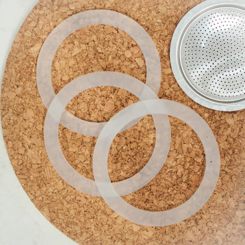 Milano Stovetop Espresso Maker Gasket Set With 3 Silicone Seals And 1 Replacement Filter Screen Kit for Moka Pots displayed on cork